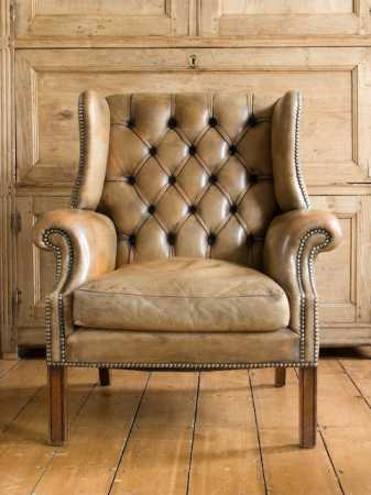 Caramel leather wing back armchair